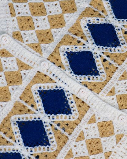 Close-up of Handcrafted Diamond Crochet Vest showcasing its unique diamond pattern in beige, white, and blue.